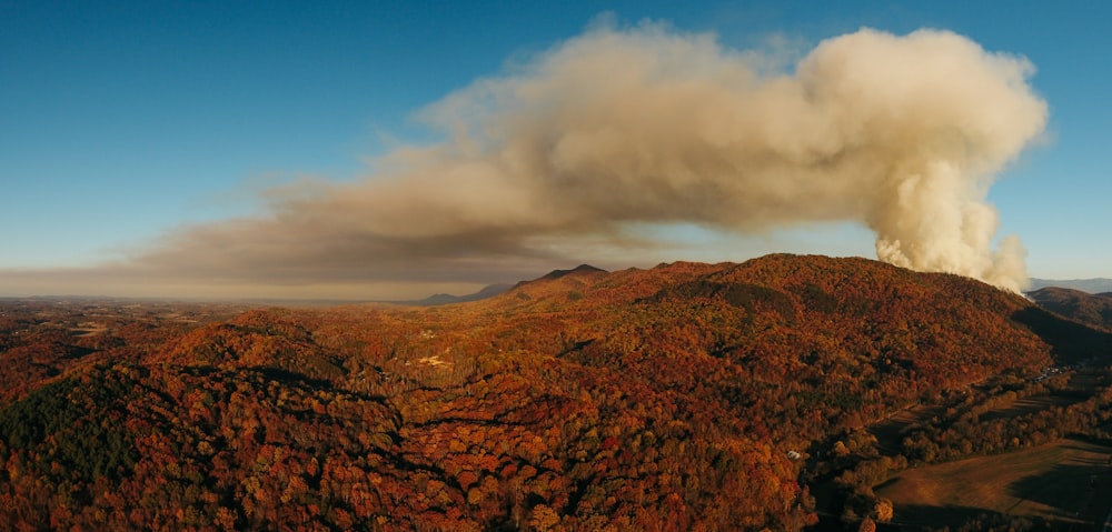 white smoke over brown mountain