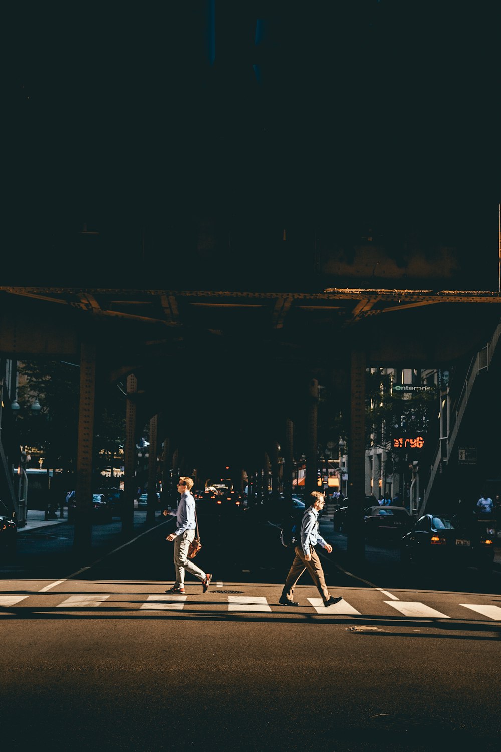 two man crossing at pedestrian lane