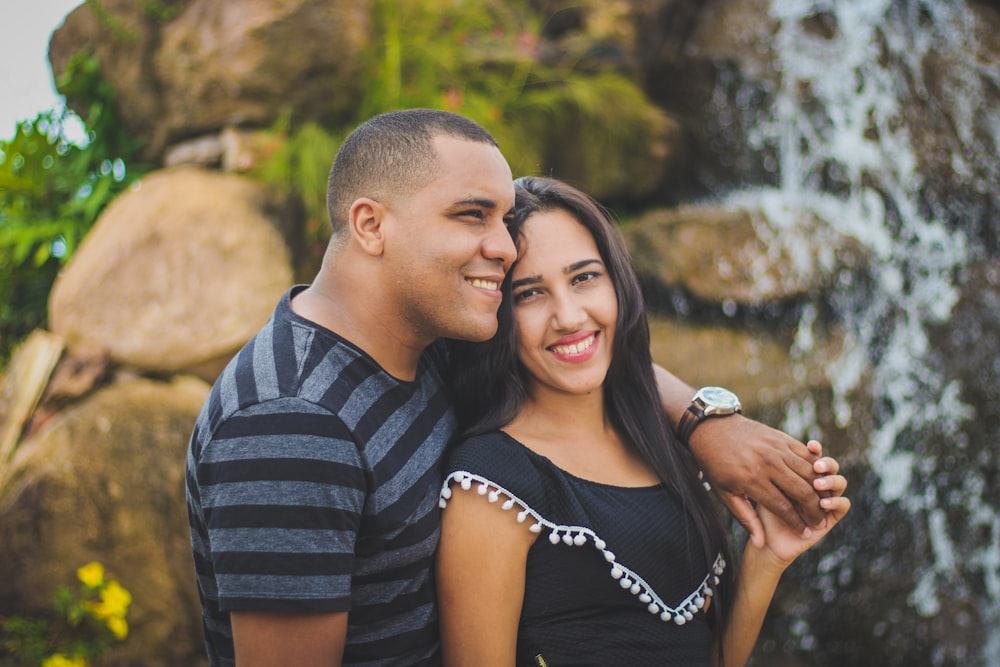 man and woman taking picture while holding their hands