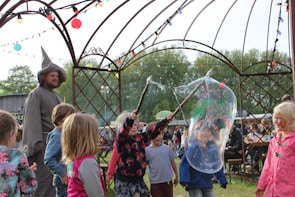 Bubble machine creating a magical atmosphere at a lively outdoor party.