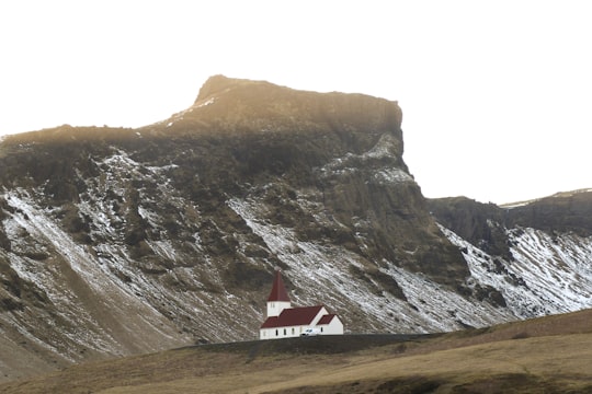 white and brown house near gray mountain in Vik Iceland
