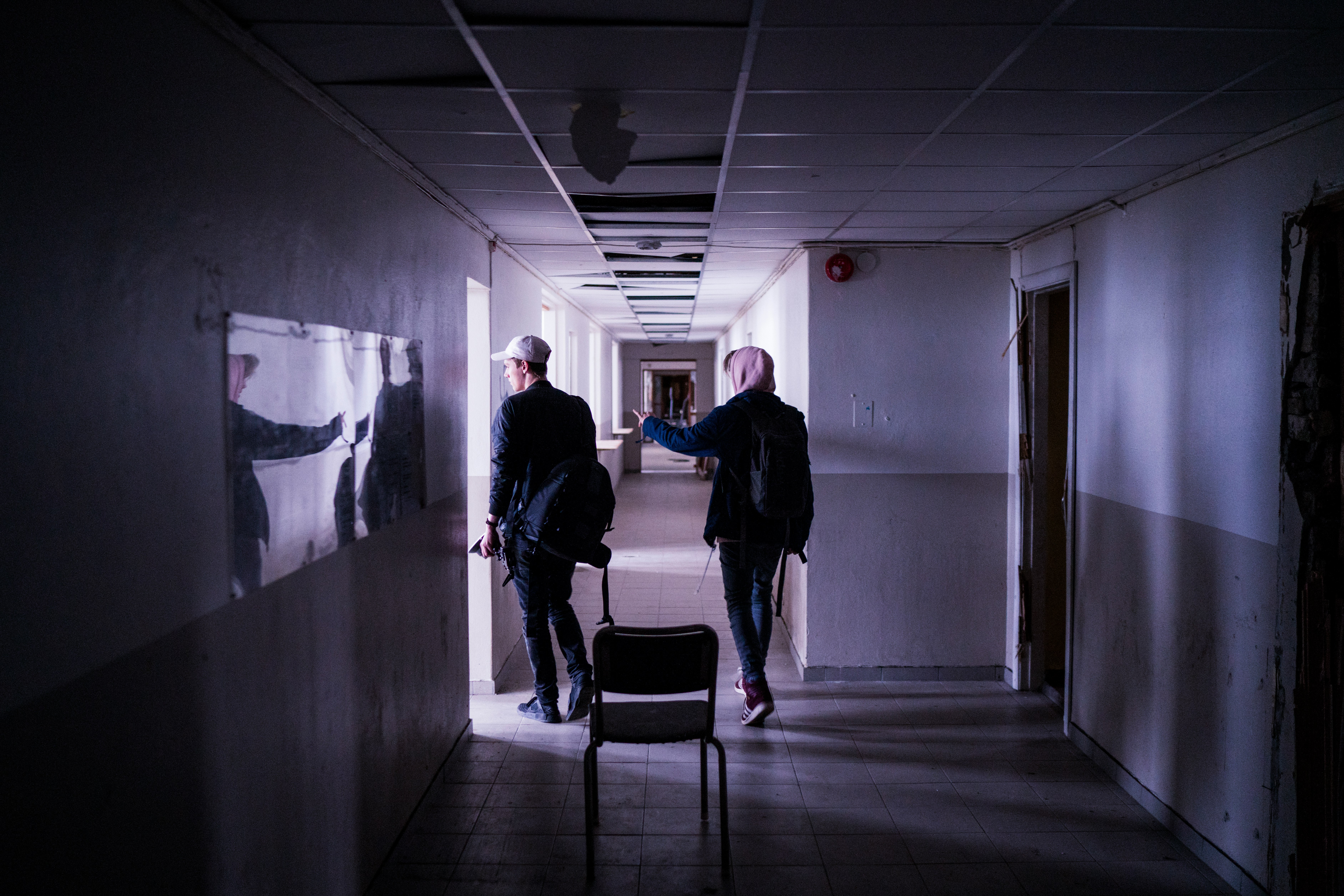 two men walking on corridor