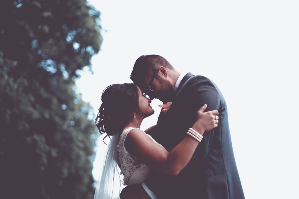 man and woman holding and looking each other