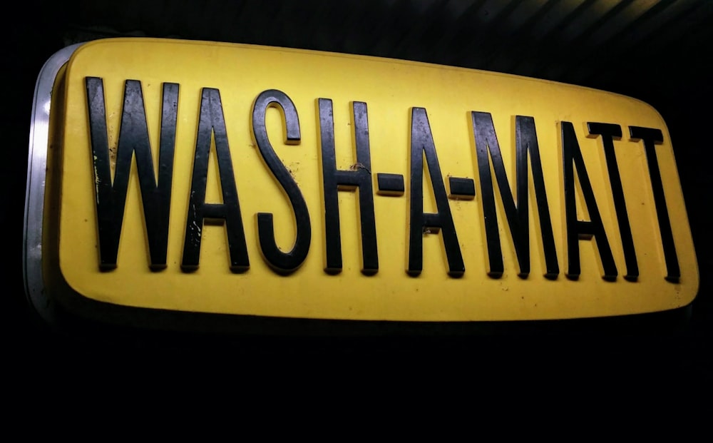 black and yellow Wash-A-Matt signage close-up photography