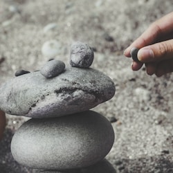 person balancing rocks