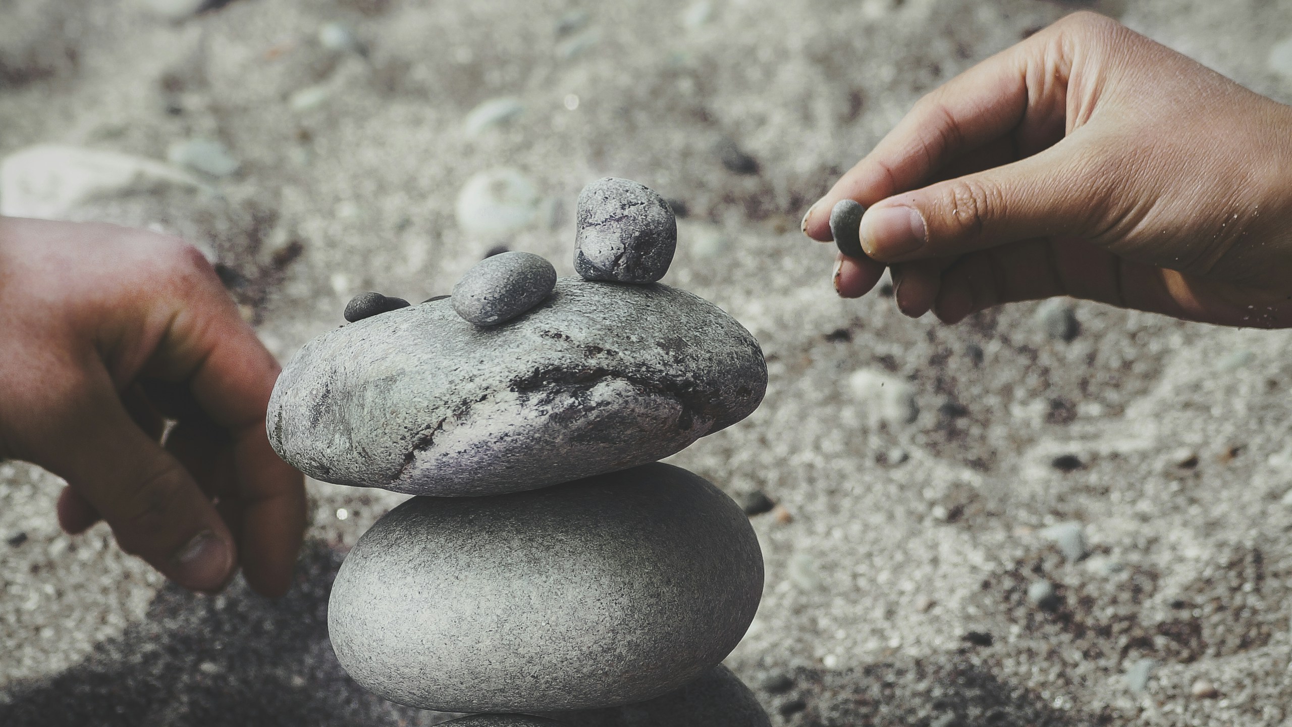 person balancing rocks