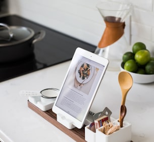 closeup photo of turned on iPad with rack on table