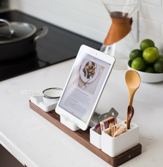 closeup photo of turned on iPad with rack on table