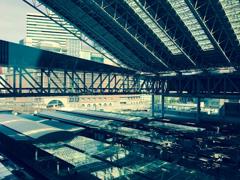 Aerial shot of a large-scale urban rail station with sleek platforms and tracks.