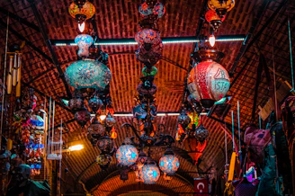 Brass lanterns glowing softly against a backdrop of deep blue Moroccan tiles.