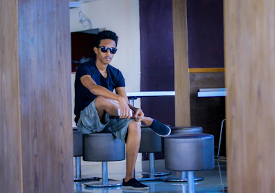 Casual outfit shot showcasing a modern man relaxing comfortably in a cozy indoor setting.