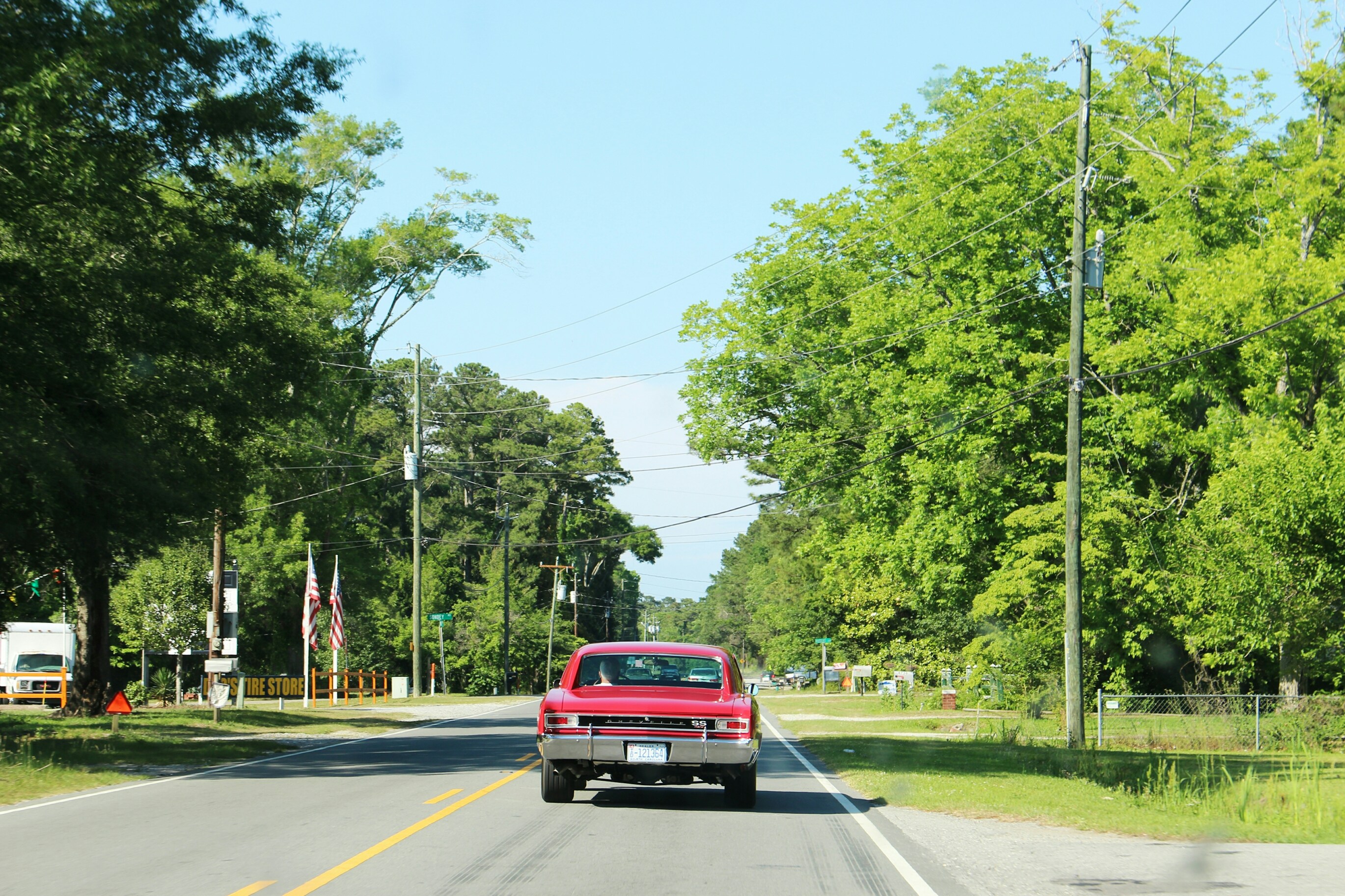 Classic reliable car on open highway, bright sunny day, clear road ahead