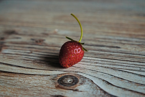strawberry on wooden surface