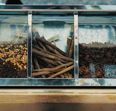 focus photography of assorted spices on display counter