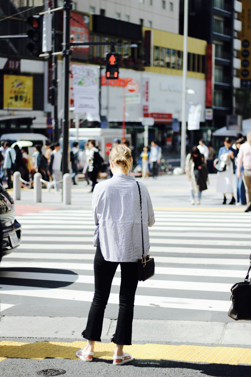 woman standing in pedestrian lane