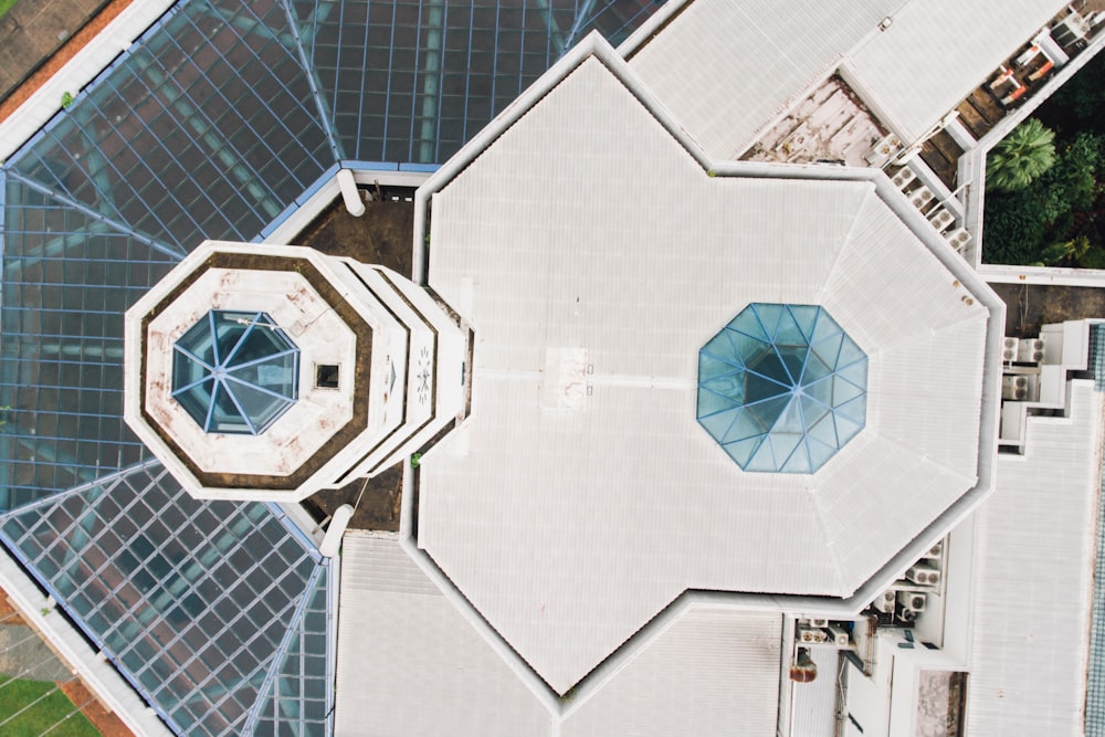 an aerial view of a building with several umbrellas