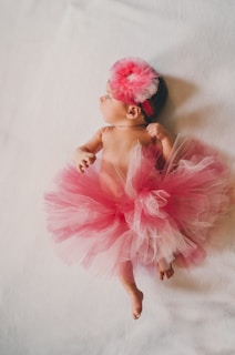 baby wearing pink tutu dress