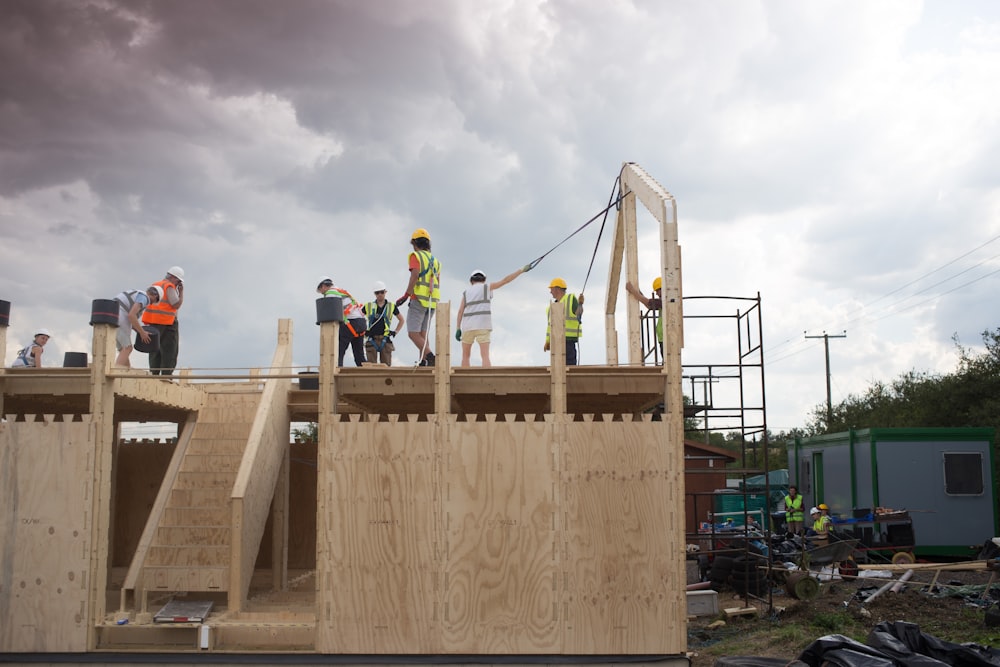 A group of construction workers building a house.