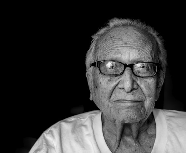 grayscale photography of man wearing shirt and eyeglasses