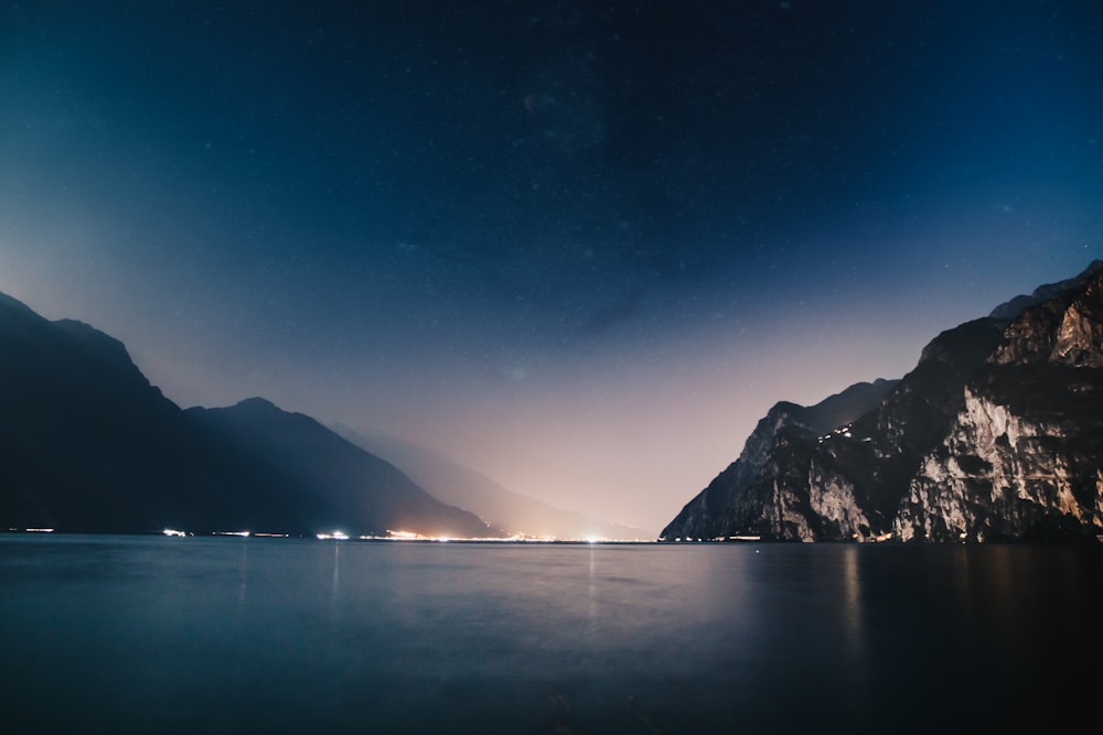 horizon scenery of mountain and sea during nighttime