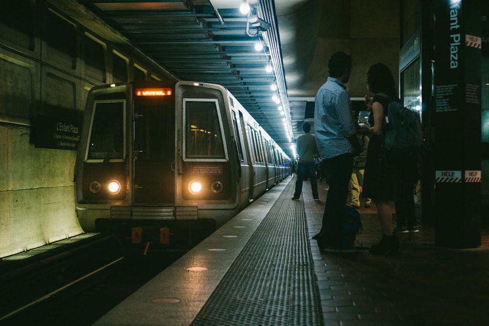 man beside woman wearing black backpack