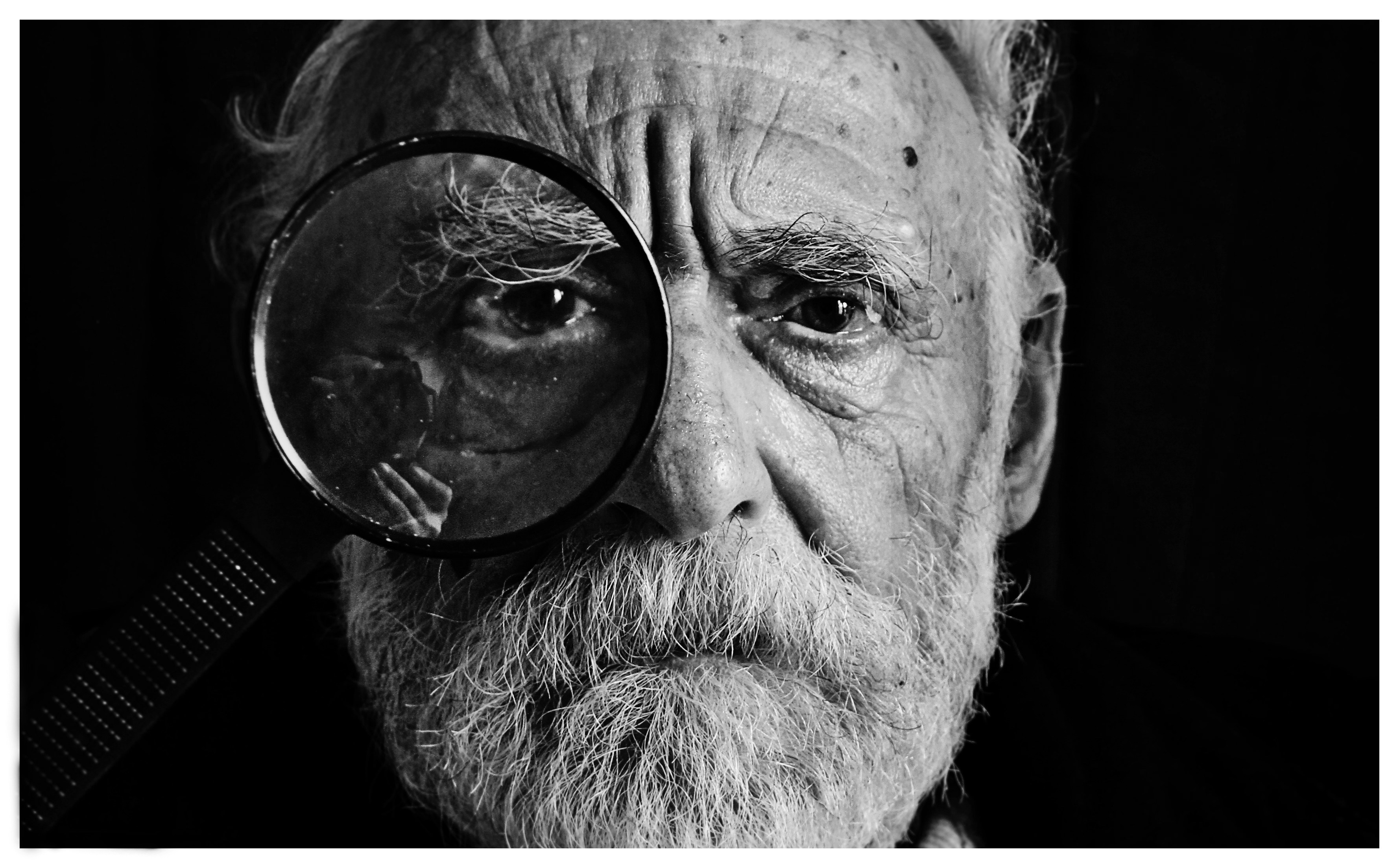 great photo recipe,how to photograph observer; grayscale photo of man using magnifying glass
