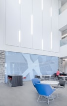 man standing beside wall and table ]