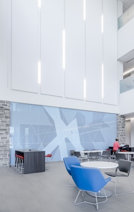 man standing beside wall and table ]