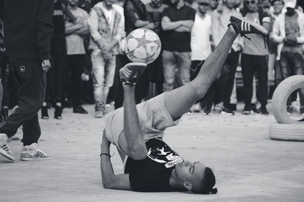 man in black and white jersey shirt playing soccer