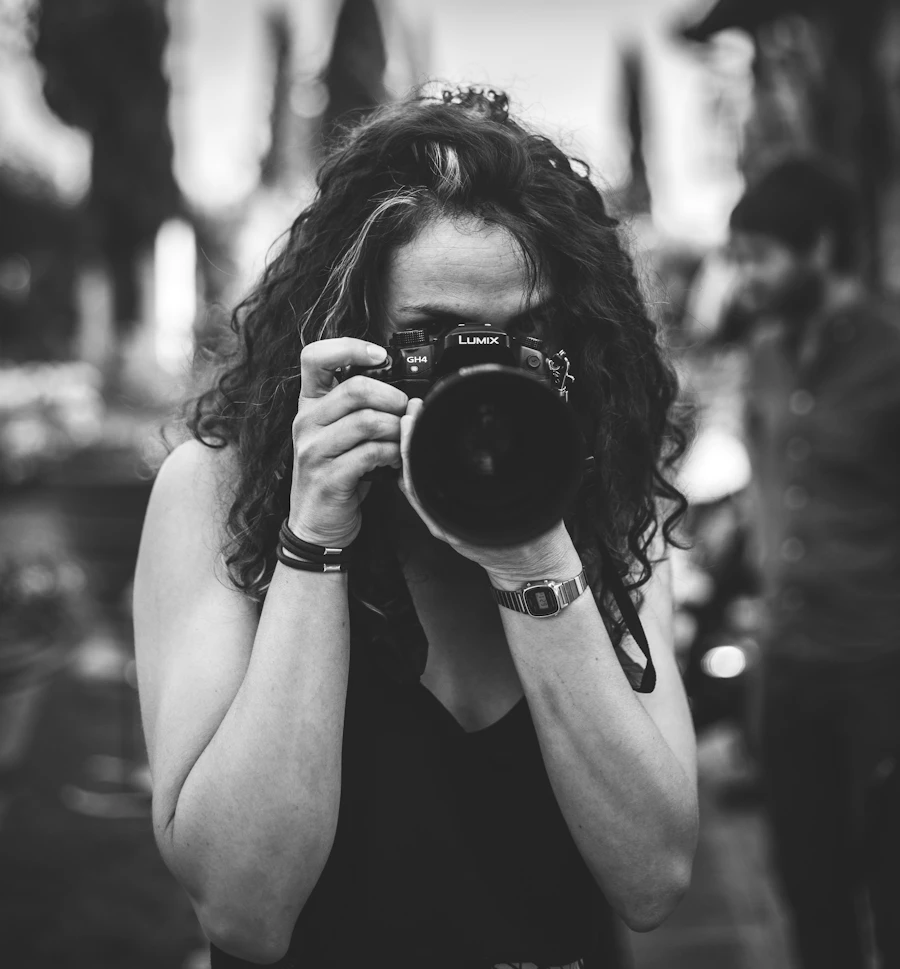 Wren Ashby holding a Lumix camera