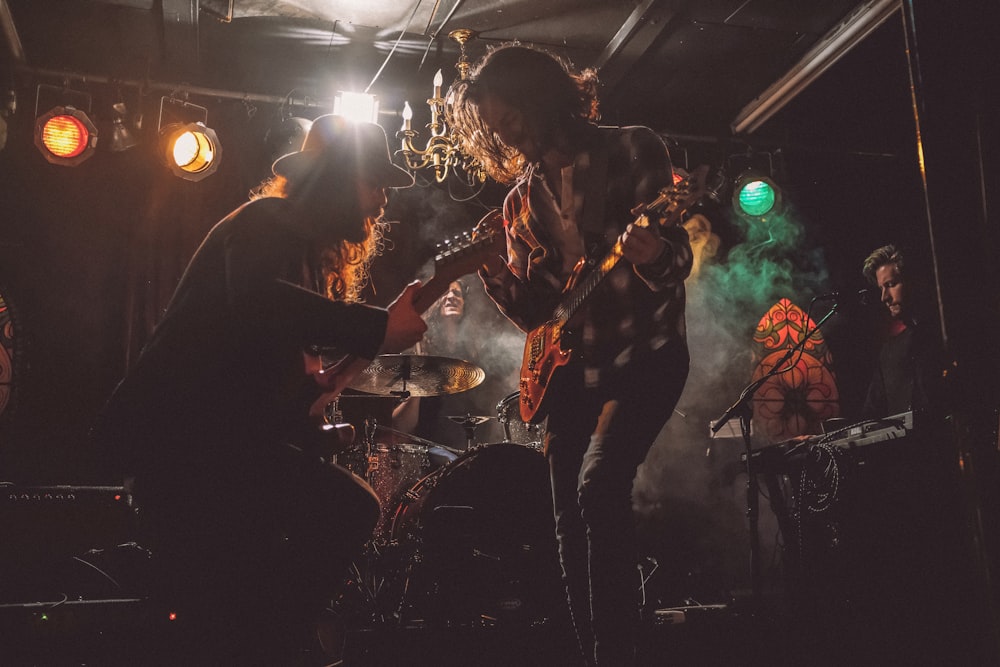 men playing guitar on stage