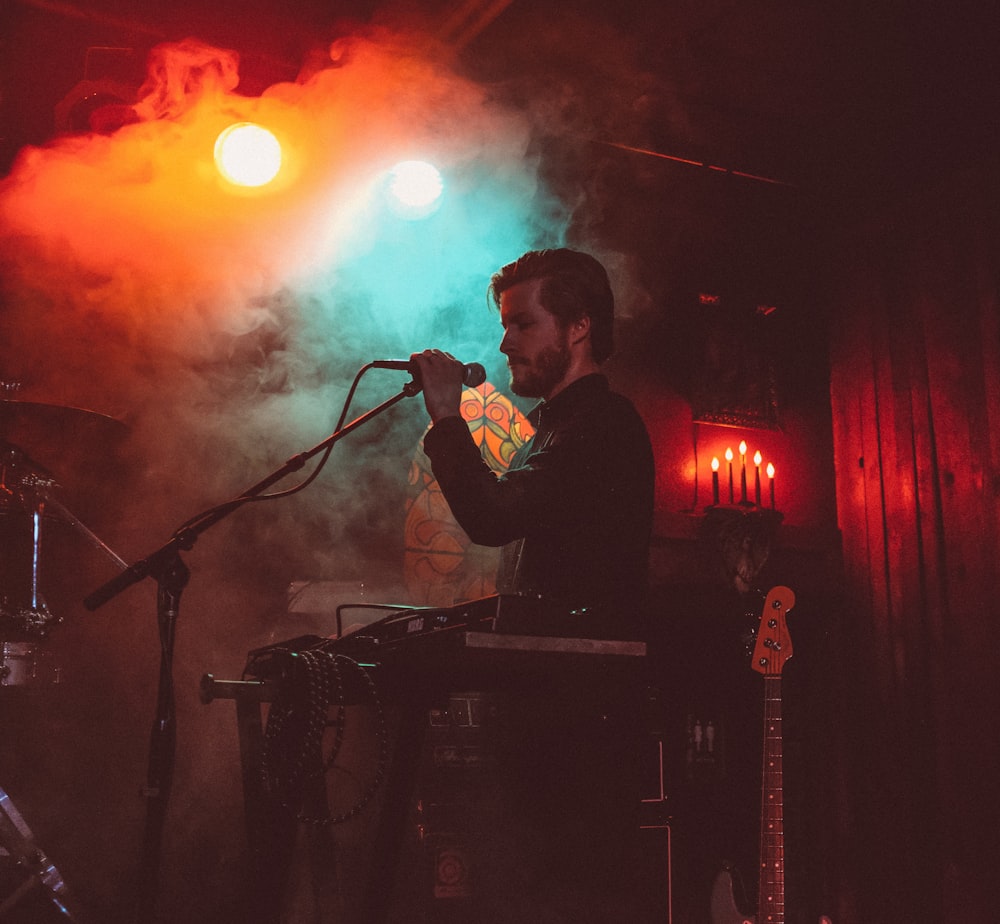 man singing on stage