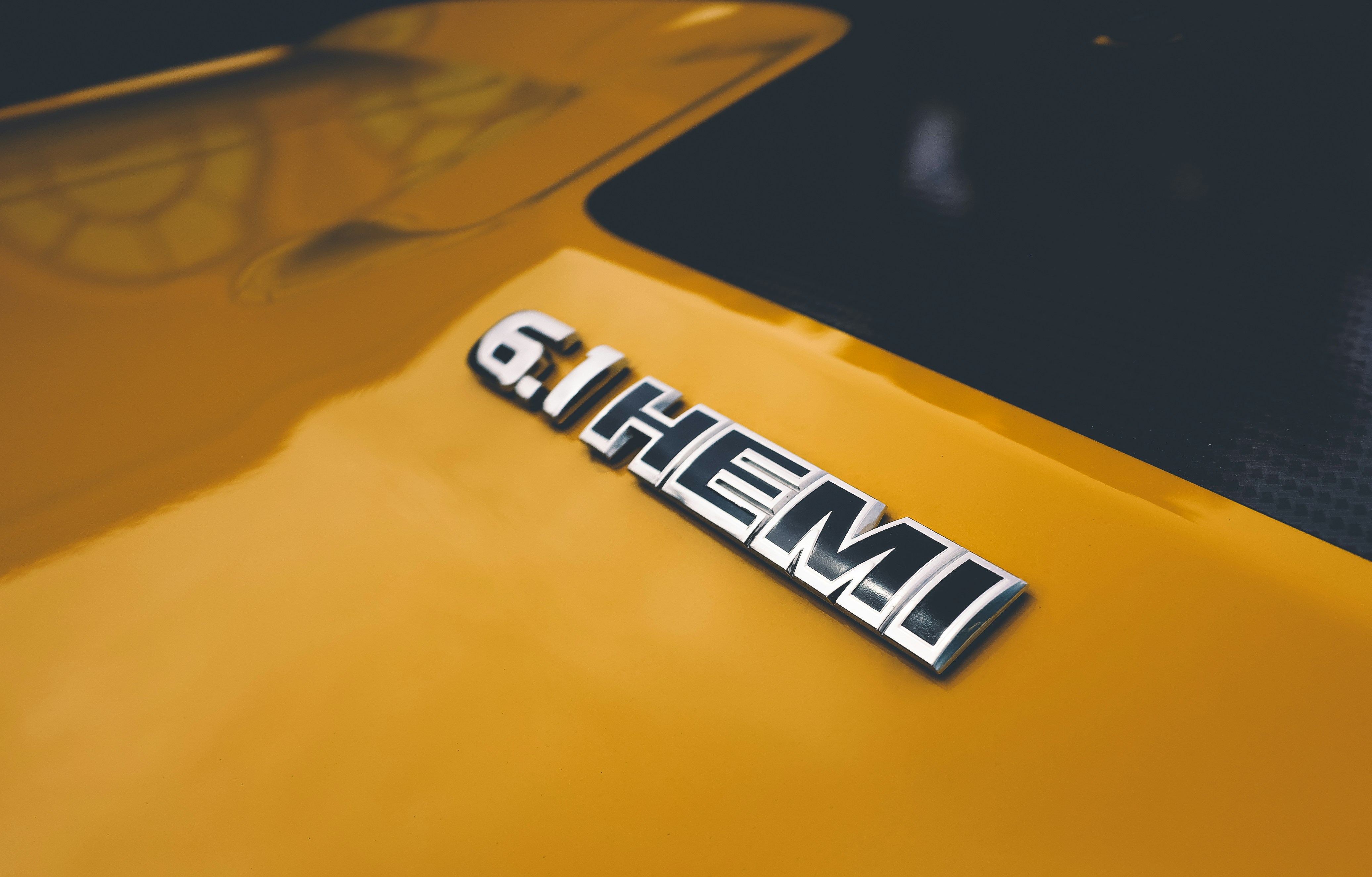 a close up of the emblem on a yellow sports car
