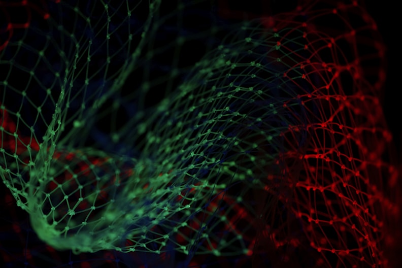 Detailed view of an abstract net with green and red hues, showcasing intricate design patterns