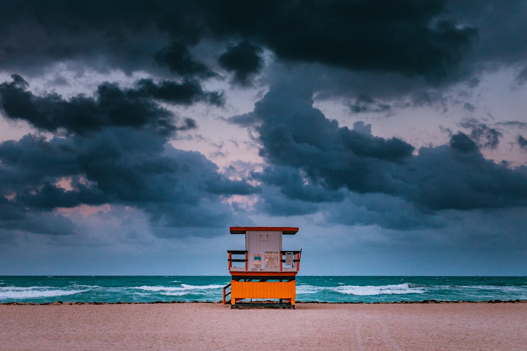 brown and white wooden table on shore, Lifeguarded