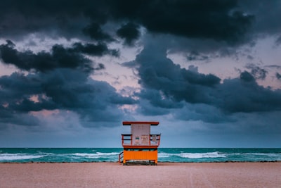 brown and white wooden table on shore