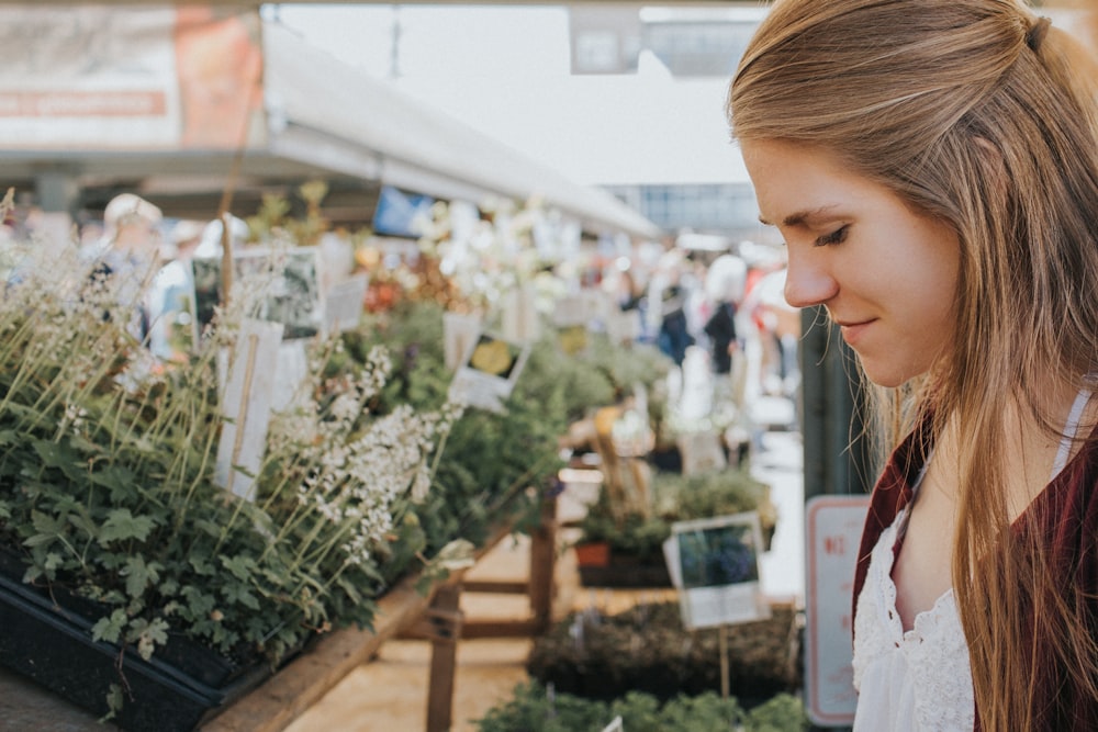 woman looking at plants