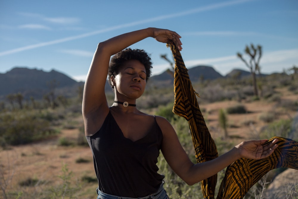 woman holding scarf with both hands