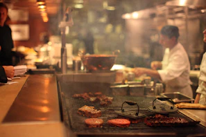 Chefs preparing fresh meals in the open kitchen of Brillo Sabor