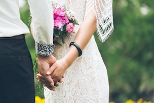 groom and bride holding hands