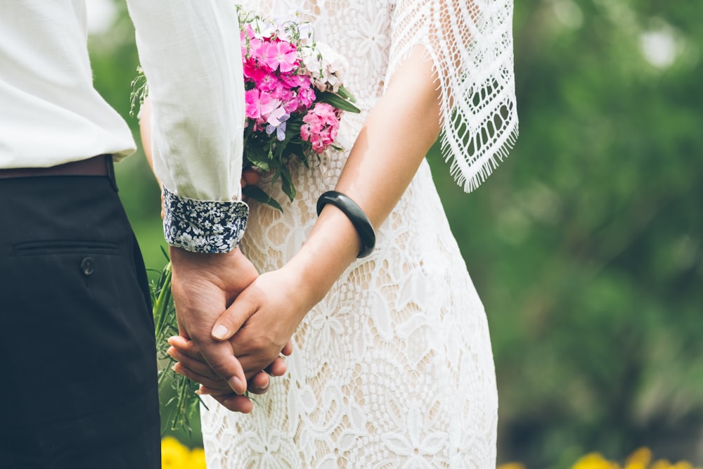 groom and bride holding hands