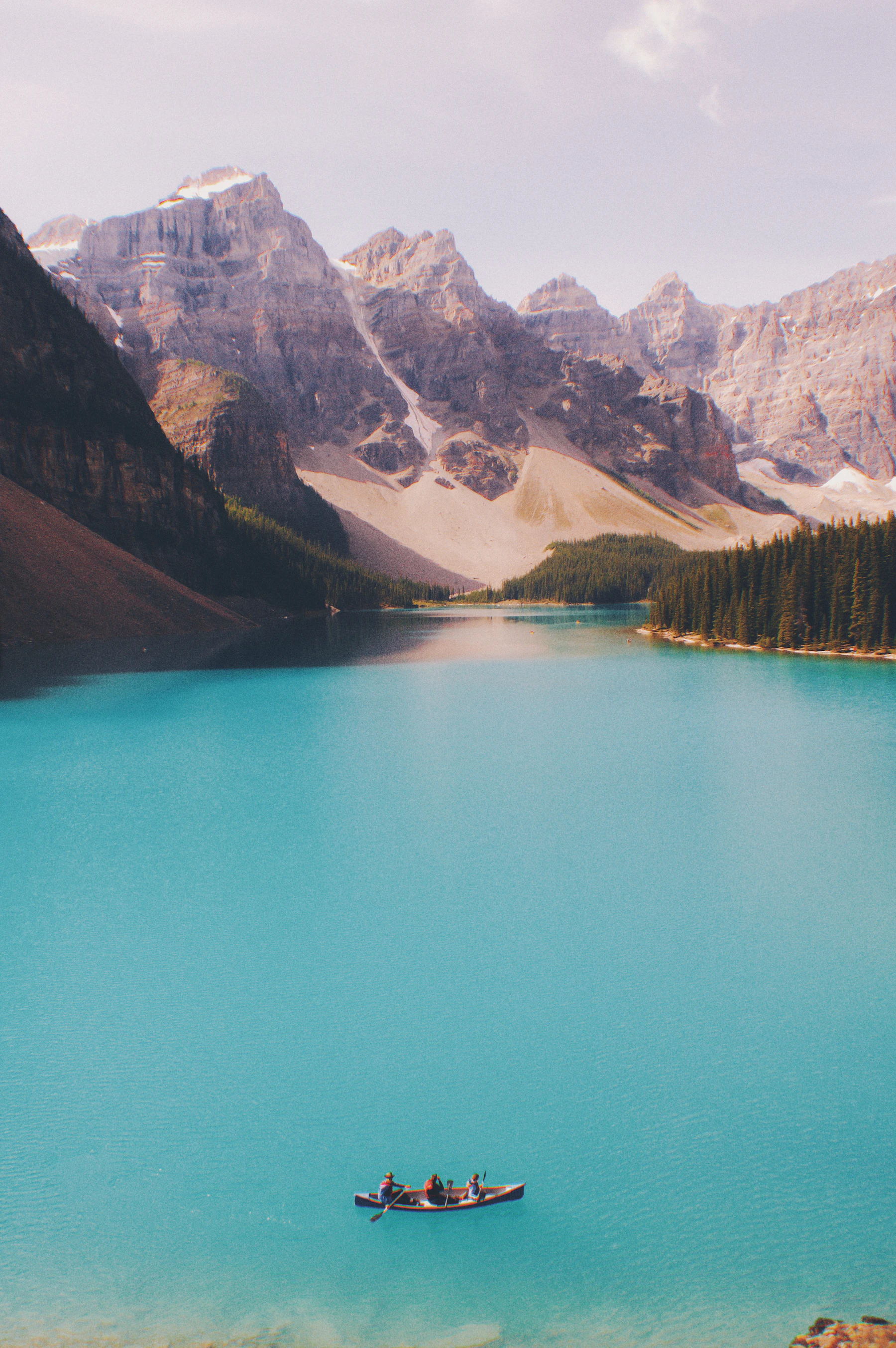 A canoe resting on the shore of a quiet wilderness lake