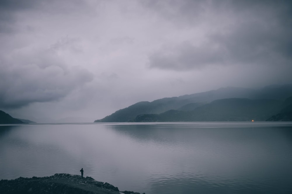 man standing on gray mountain