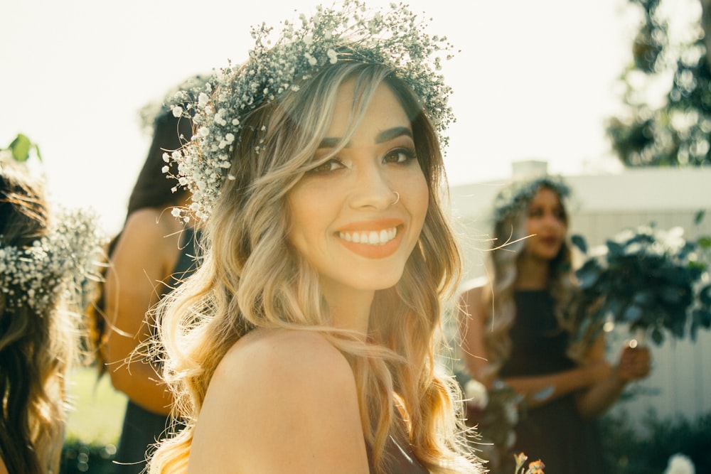 woman wearing headdress near two womens closeup photography