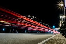Fast car transport on a nighttime road.