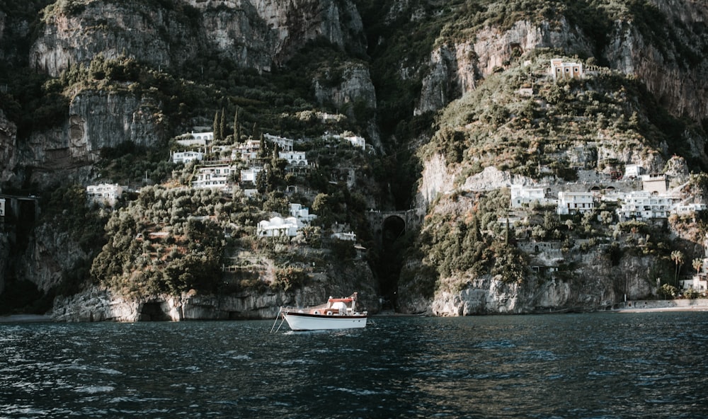 white motorboat on body of water