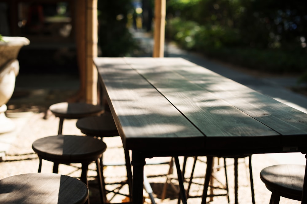 Empty wood table with stools on an outdoor patio