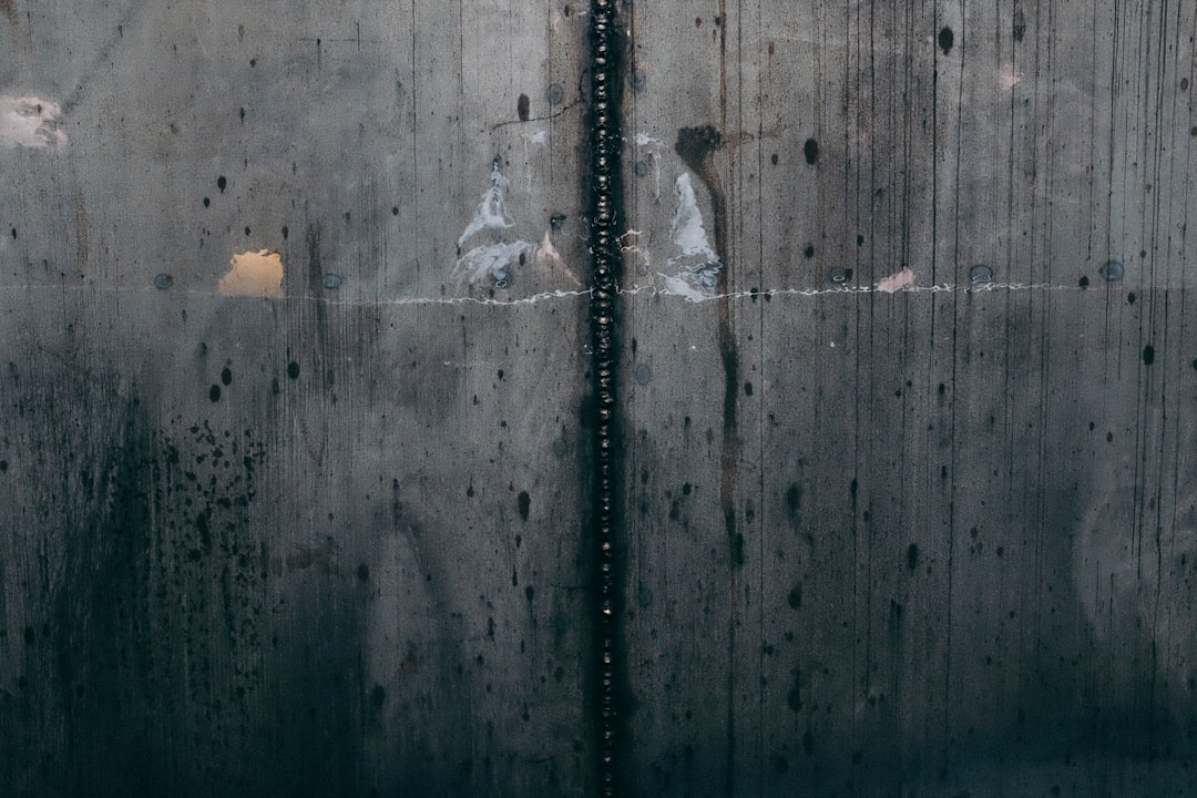 a close up of a metal door with water droplets on it,