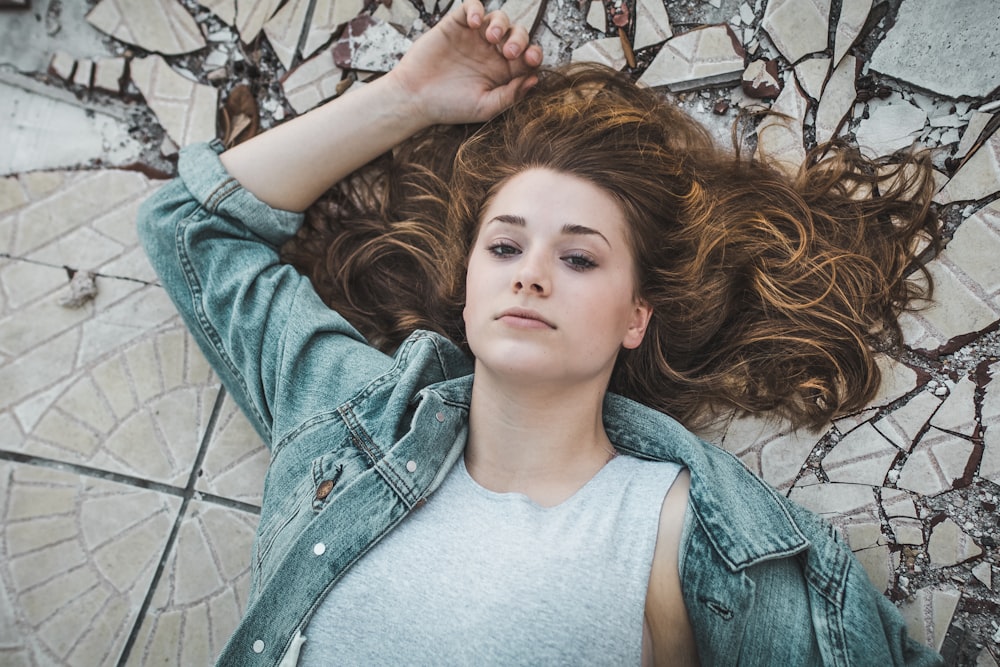 woman laying on crack tiles