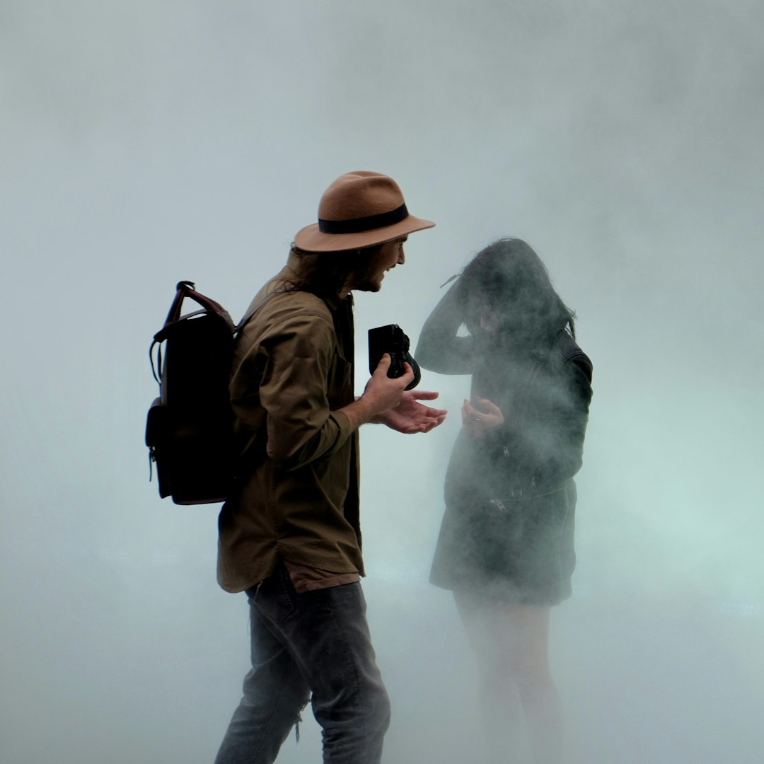 man holding camera in front of girl